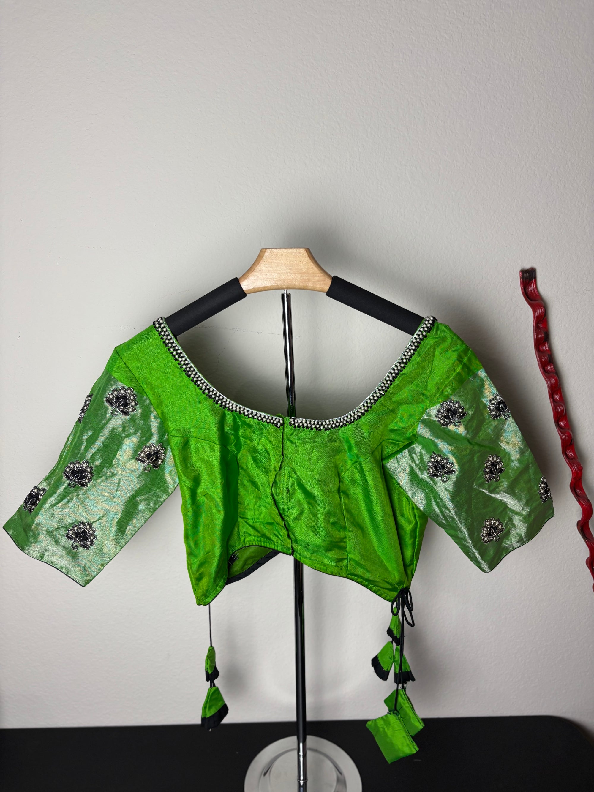 Green Blouse with Purple Flowers on the Hands