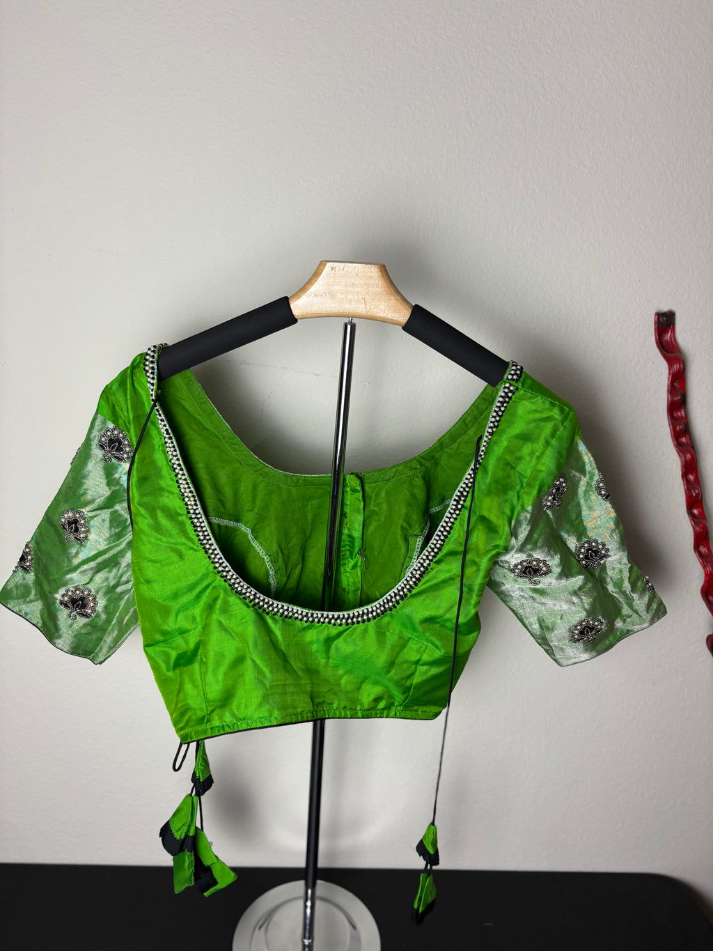 Green Blouse with Purple Flowers on the Hands
