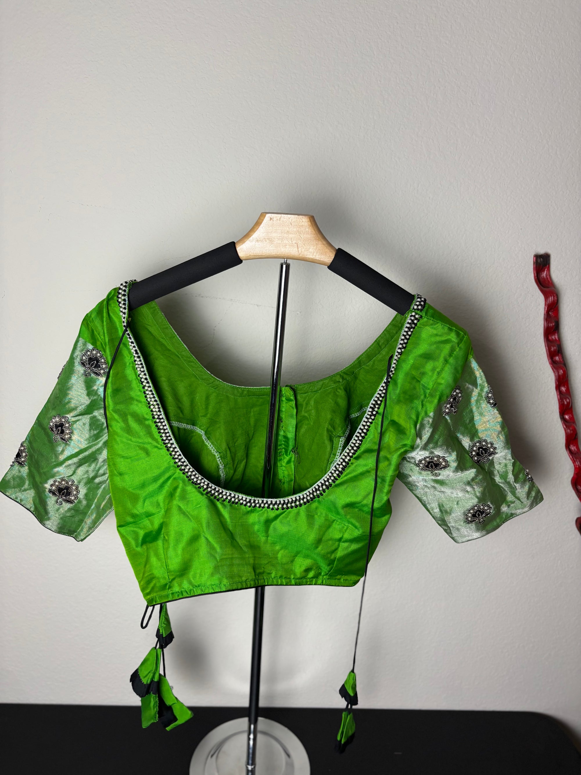 Green Blouse with Purple Flowers on the Hands